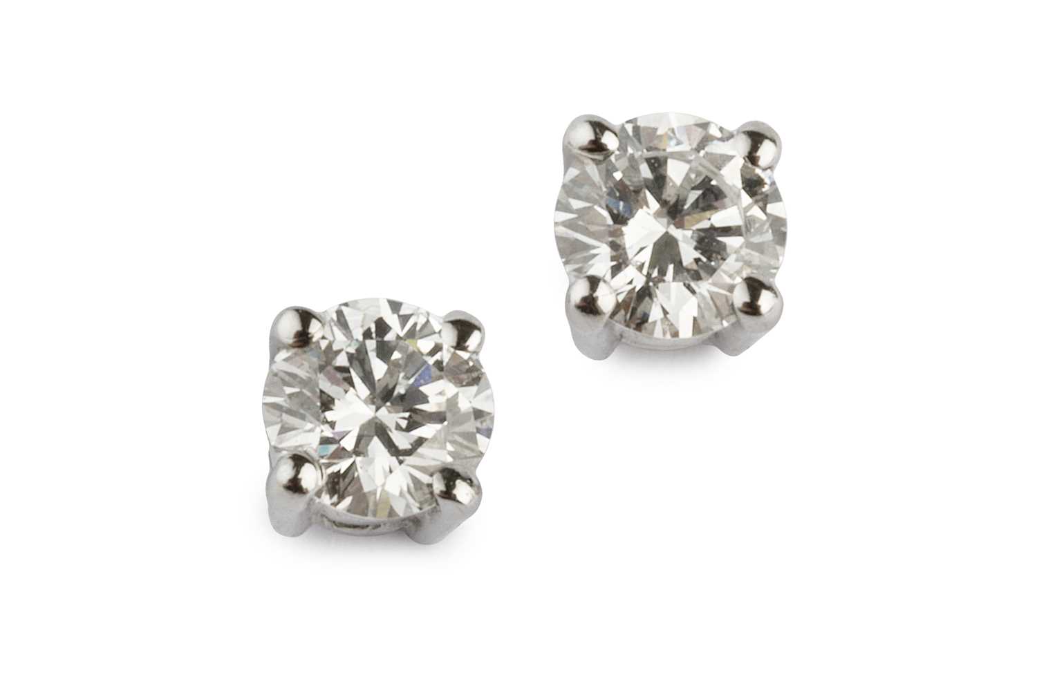 Lot 95 - A pair of diamond ear studs, each round...