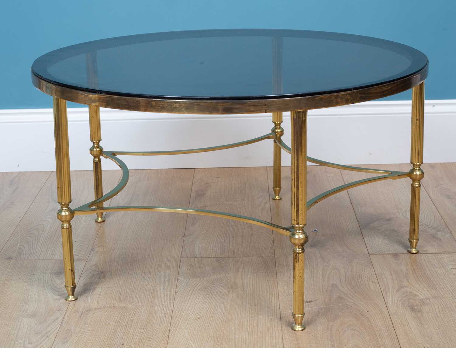 Lot 447 - A brass coffee table with a glass top