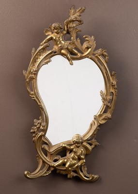 Lot 203 - A small gilt framed brass wall mirror