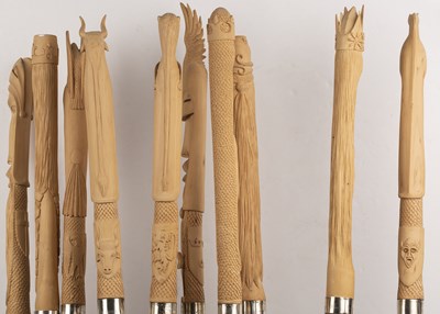 Lot 244 - A set of ten birch wood staffs, each carved...