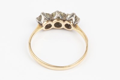Lot 75 - A diamond three stone ring, the slightly...