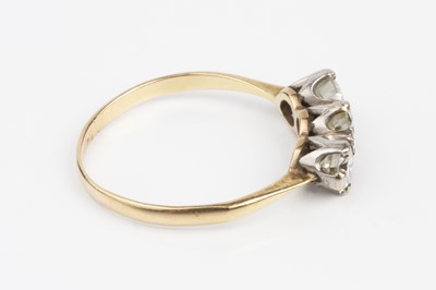 Lot 75 - A diamond three stone ring, the slightly...