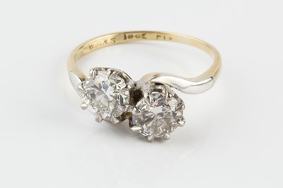 Lot 90 - A diamond two stone crossover ring, the round...