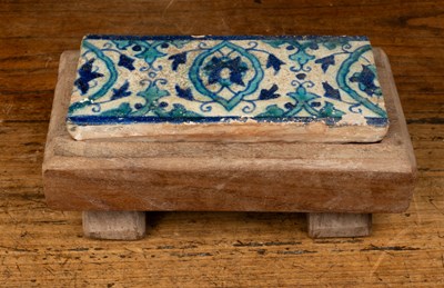 Lot 146 - A pottery tile with blue and turquoise foliate decoration