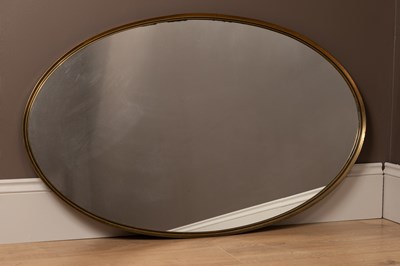 Lot 391 - A brass framed oval mirror in the manner of Maison Jansen