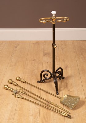 Lot 223 - A set of brass fire irons in a stand