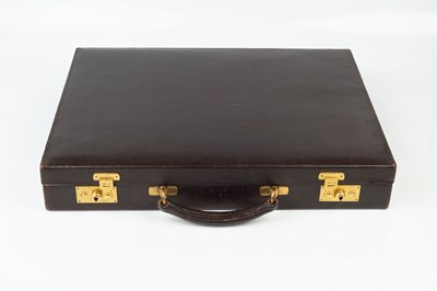 Lot 297 - A dark brown leather briefcase, containing...