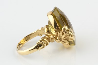 Lot 154 - A yellow quartz single stone dress ring by...