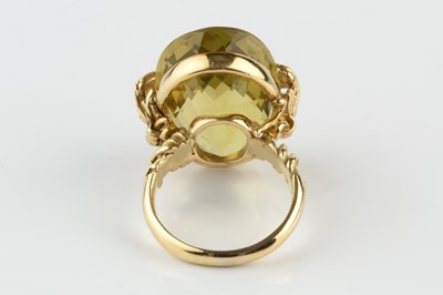 Lot 154 - A yellow quartz single stone dress ring by...