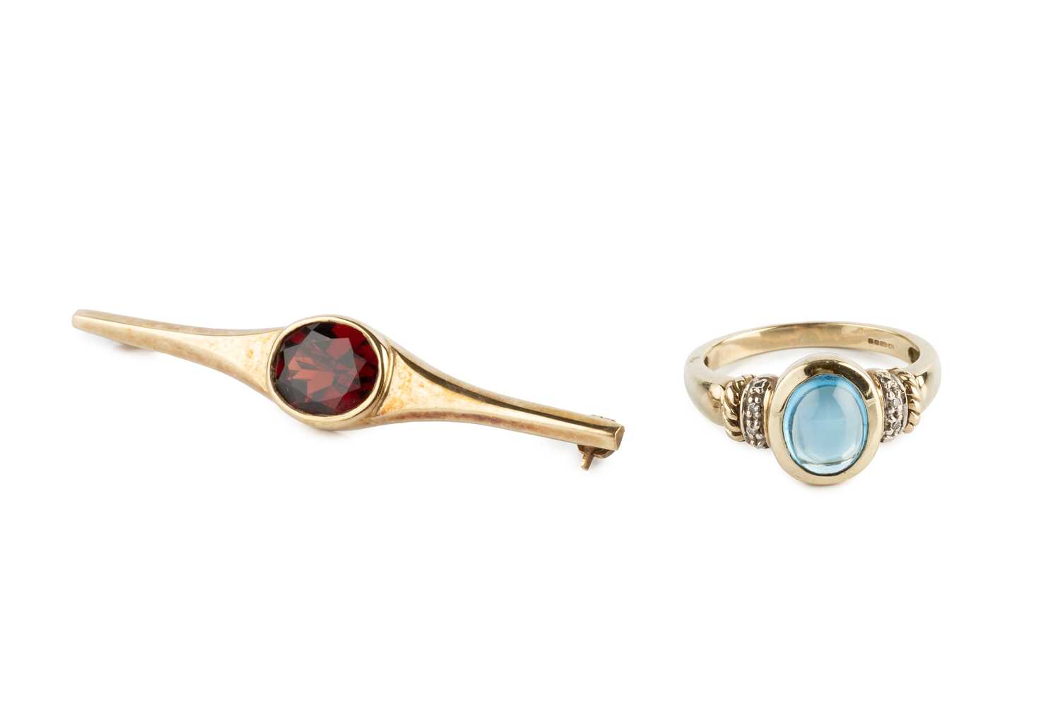 Lot 274 - A gem set dress ring, the oval cabochon blue...