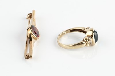Lot 274 - A gem set dress ring, the oval cabochon blue...