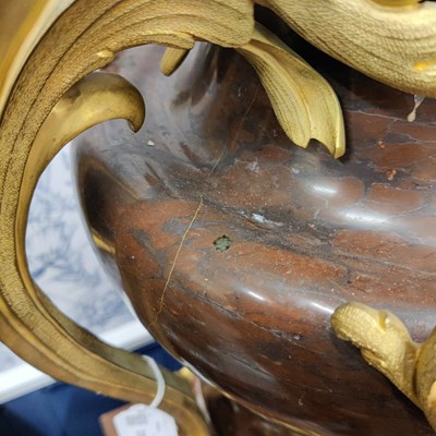 Lot 158 - A pair of French Empire style rouge marble lidded urns