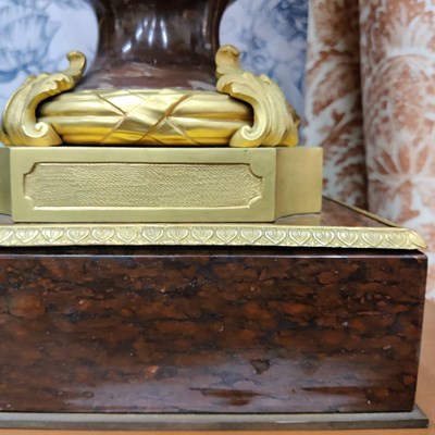 Lot 158 - A pair of French Empire style rouge marble lidded urns