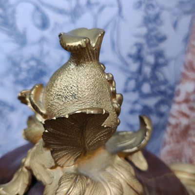 Lot 158 - A pair of French Empire style rouge marble lidded urns