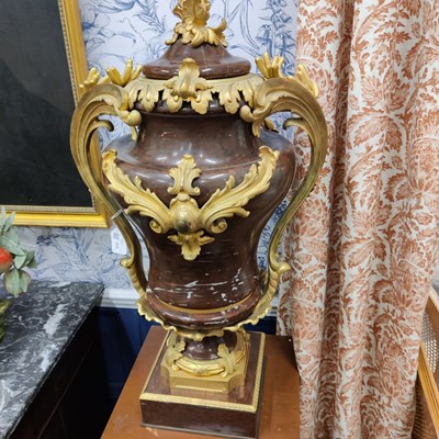 Lot 158 - A pair of French Empire style rouge marble lidded urns