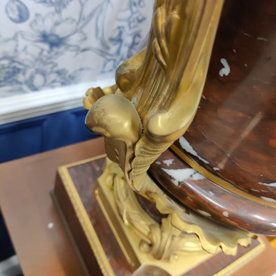 Lot 158 - A pair of French Empire style rouge marble lidded urns