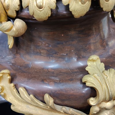 Lot 158 - A pair of French Empire style rouge marble lidded urns