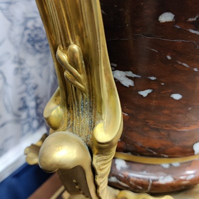 Lot 158 - A pair of French Empire style rouge marble lidded urns