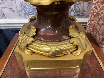 Lot 158 - A pair of French Empire style rouge marble lidded urns
