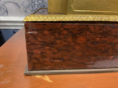 Lot 158 - A pair of French Empire style rouge marble lidded urns