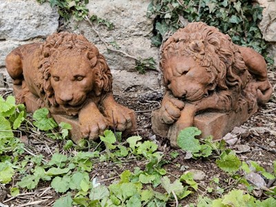 Lot 535 - A pair of cast terracotta recumbent lions after Canova