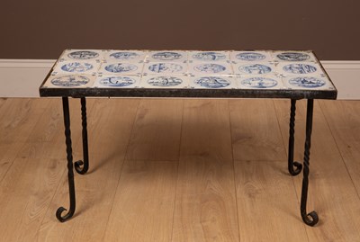 Lot 174 - A wrought iron coffee table inset with eighteen blue and white Delftware tiles
