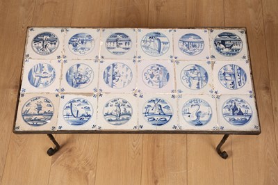 Lot 174 - A wrought iron coffee table inset with eighteen blue and white Delftware tiles