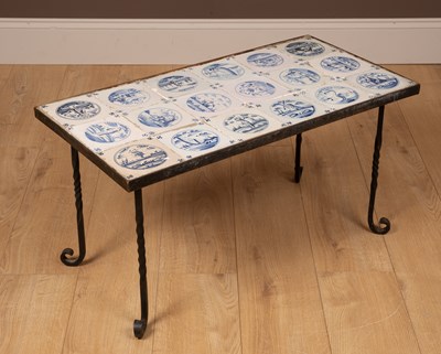 Lot 174 - A wrought iron coffee table inset with eighteen blue and white Delftware tiles