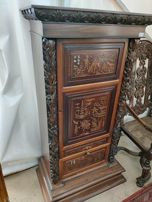 Lot 70 - A pair of 20th-century Chinese hardwood panel inset pedestal cupboards