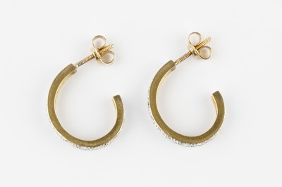 Lot 84 - A pair of diamond ear hoops, each inset with a...