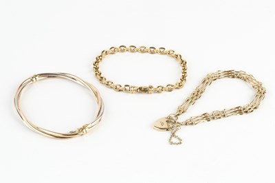 Lot 204 - A three colour precious metal bangle, of...