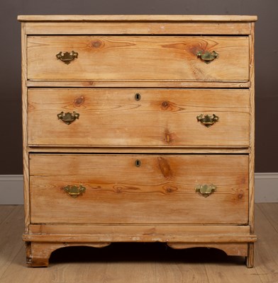 Lot 102 - A 20th century pine chest of three long drawers