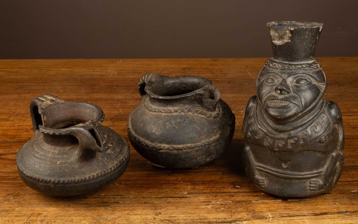 Lot 139 - Three possibly South American pottery vessels, one figural