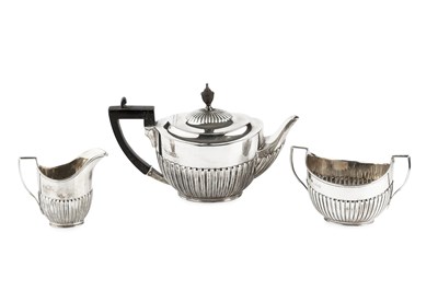 Lot 732 - A silver three piece tea service, of half...