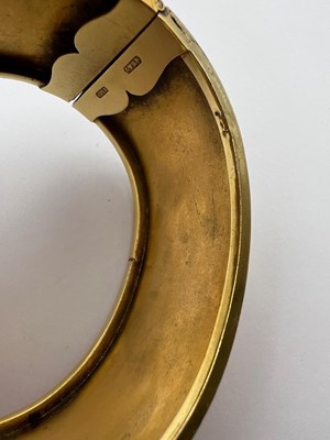 Lot 23 - An Archaeological Revival gold bangle, of...