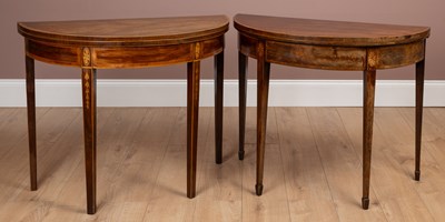Lot 140 - A near pair of George III mahogany demi lune fold over card tables