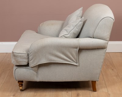Lot 125 - A deep Howard style armchair and stool