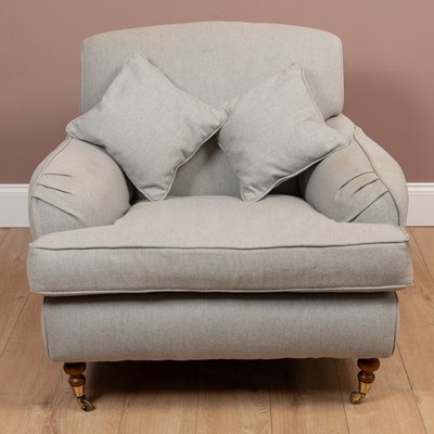 Lot 125 - A deep Howard style armchair and stool