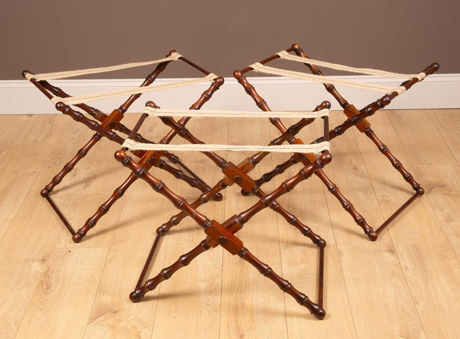 Lot 318 - Three mahogany folding luggage racks