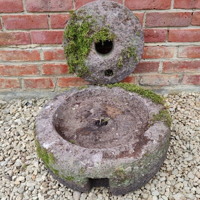Lot 501 - A carved stone grinding quern