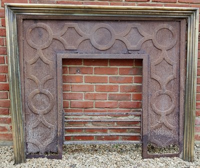 Lot 590 - A Cast Iron Fireplace Insert with a brass fire surround