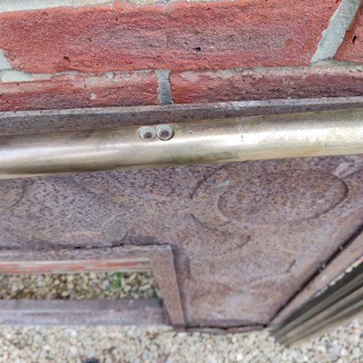 Lot 590 - A Cast Iron Fireplace Insert with a brass fire surround