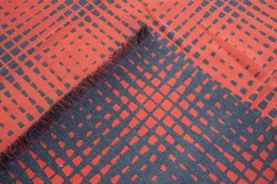 Lot 395 - A modern woven rug with a red ground