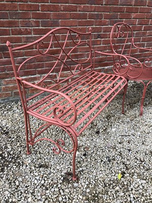 Lot 562 - A red painted garden furniture