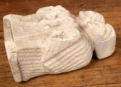 Lot 563 - A small carved limestone sculpture