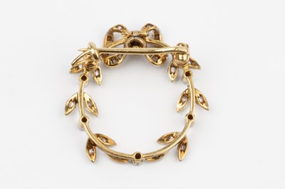 Lot 29 - A diamond set wreath brooch, formed of a bow,...