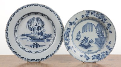 Lot 242 - Two Delft tin glazed plates the larger example...