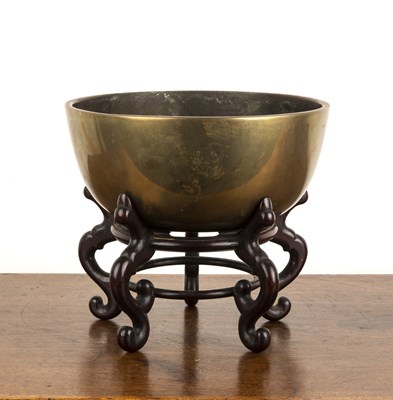 Lot 463 - Heavy bronze bowl on a hardwood stand Chinese,...