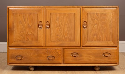 Lot 224 - A light elm Ercol sideboard