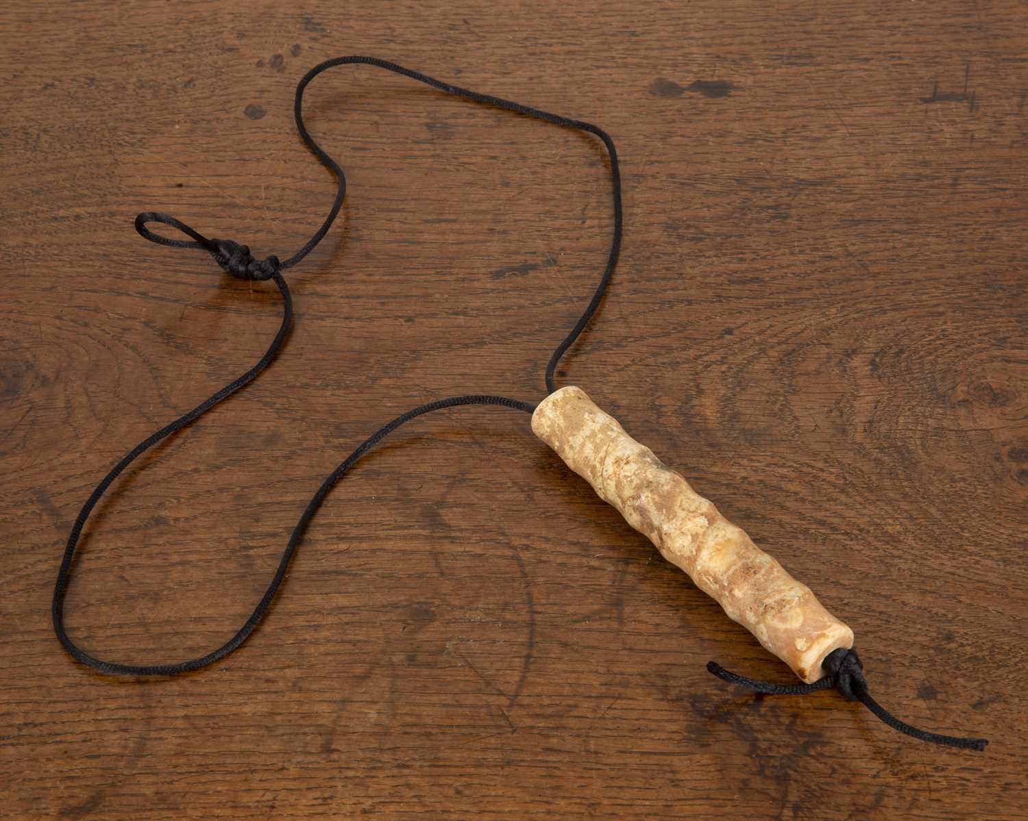 Lot 489 - Long nephrite jade bead in the form of a...
